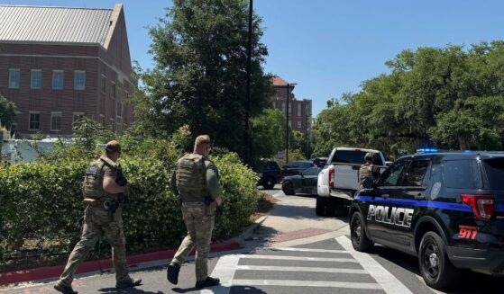 Dozens of patrol vehicles, including a forensics van, are stationed outside of Florida State University’s student union building, the scene of a shooting, Thursday in Tallahassee, Florida. (Kate Payne / AP)
