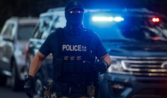 Immigration and Customs Enforcement officials prepare to arrest an illegal immigrant with criminal record in Los Angeles, California, on Sept. 8. 2022.