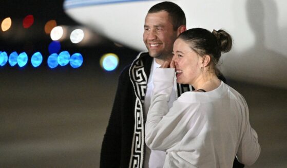 U.S.-Russian ballet dancer Ksenia Karelina, right, and her boyfriend South African boxer Chris van Heerden, left, embrace as she arrives at Joint Base Andrews in Maryland, following her release from Russia on Thursday.