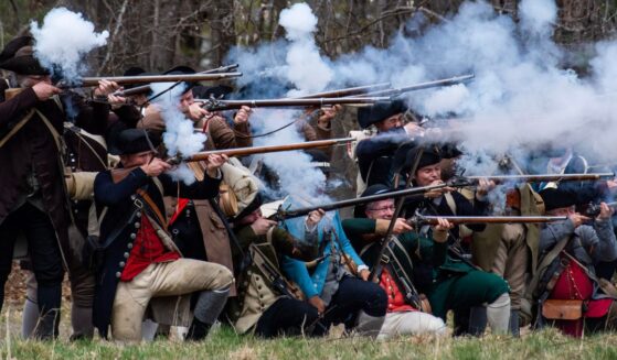 American Revolution reenactors fire a salvo Minute Men National Historical Park in Lincoln, Massachusetts on April 15, 2023.