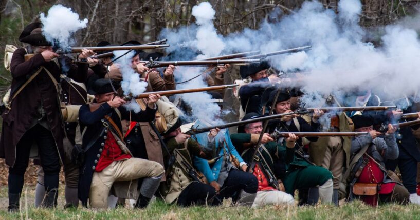 American Revolution reenactors fire a salvo Minute Men National Historical Park in Lincoln, Massachusetts on April 15, 2023.