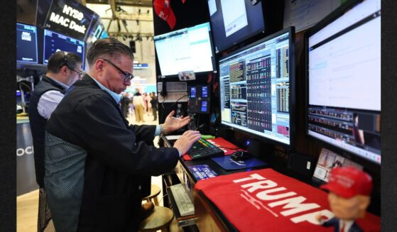 Traders work on the floor of the New York Stock Exchange during morning trading Tuesday in New York City. The market made great gains by the end of the day on news that tariff tensions with China may be easing.