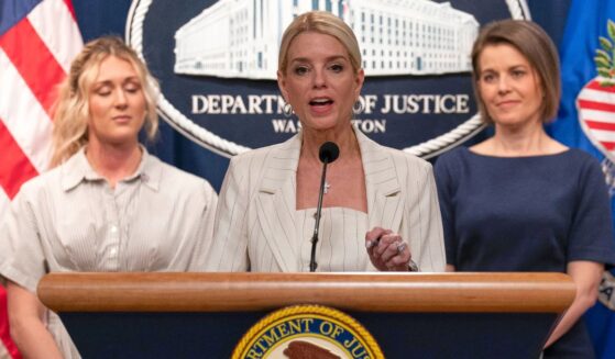 Attorney General Pam Bondi, center, flanked by athlete and influencer Riley Gaines, left, and Maine Republican Rep. Laurel Libby, right, speaks Wednesday during a news conference at the Department of Justice headquarters in Washington, D.C.