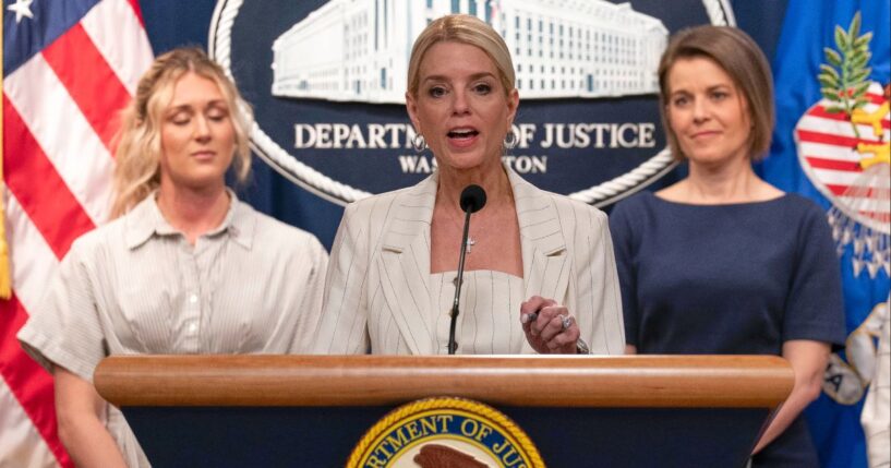 Attorney General Pam Bondi, center, flanked by athlete and influencer Riley Gaines, left, and Maine Republican Rep. Laurel Libby, right, speaks Wednesday during a news conference at the Department of Justice headquarters in Washington, D.C.
