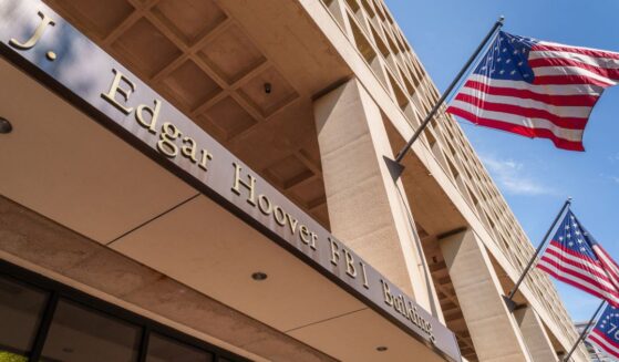Historical versions of the U.S. flag fly over the entrance to the Federal Bureau of Investigation (FBI) headquarters building on September 15, 2024