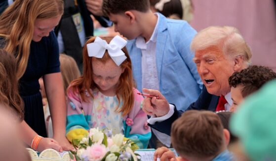 President Donald Trump talks with a group of kids durning the White House Easter Egg Roll Monday.