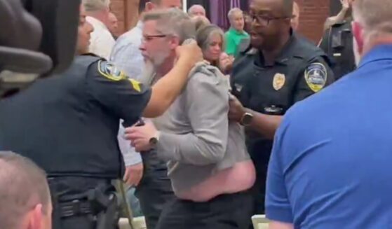 During a Tuesday town hall featuring Rep. Marjorie Taylor Greene, several left-wing protesters, including the one pictured, were removed by police.