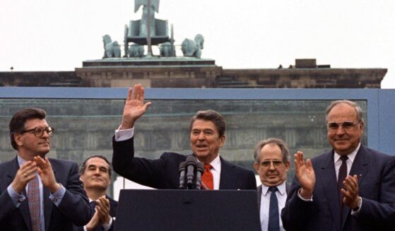 President Ronald Reagan, center, acknowledges the crowd after his speech in front of the Brandenburg Gate in West Berlin on June 12, 1987.