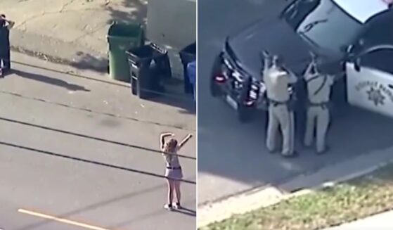 A news crew captured video of Los Angeles police officers at the scene, right, where a woman was shot after allegedly pointing a gun at officers.