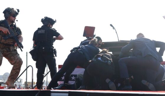 Then-Republican presidential candidate Donald Trump is tackled to the stage by Secret Service agents after being struck by a bullet in Butler, Pennsylvania, on July 13.