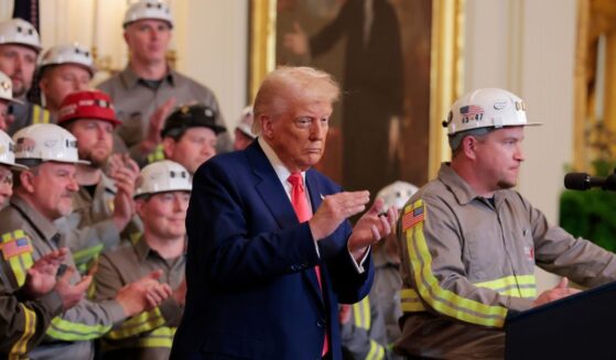 President Donald Trump listens as coal miner Jeff Crowe speaks during an executive order signing ceremony in the East Room of the White House on April 8, 2025, in Washington, D.C.