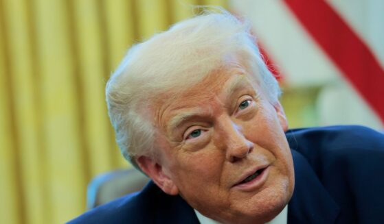 President Donald Trump speaks to reporters while in the Oval Office of the White House on April 9, 2025, in Washington, D.C.
