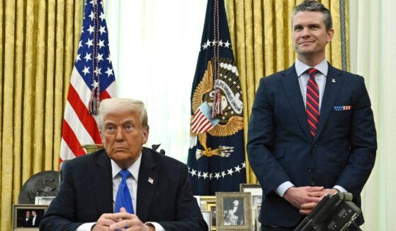 President Donald Trump, left, and Defense Secretary Pete Hegseth, right, participate during an event in the Oval Office of the White House in Washington, D.C., on March 21.