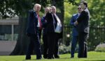 President Donald Trump inspects the north lawn Wednesday with members of the White House grounds crew to look for a place to put a flag pole. The president said he wants to put two 100-foot flag poles, one on the north lawn and another on the south lawn.